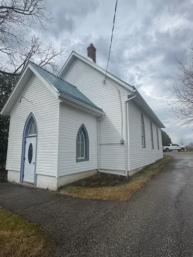 Front exterior of a church building with finished siding and roofline.