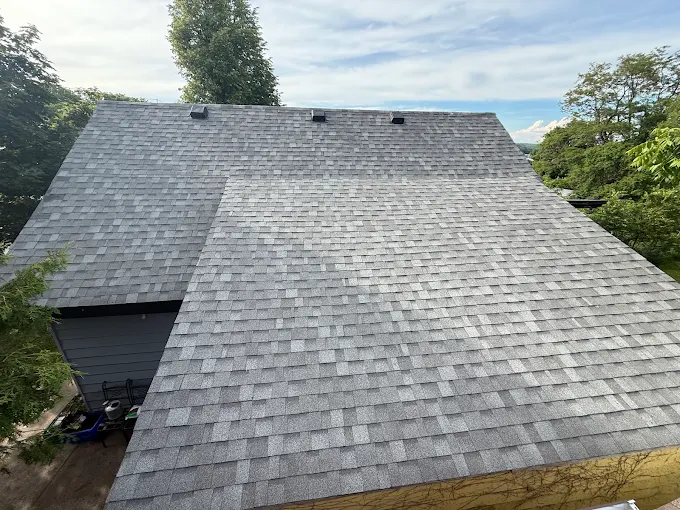 Completed asphalt shingle roof viewed from above the eaves.