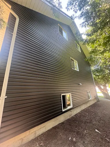 Close view of dark horizontal siding across an exterior wall.