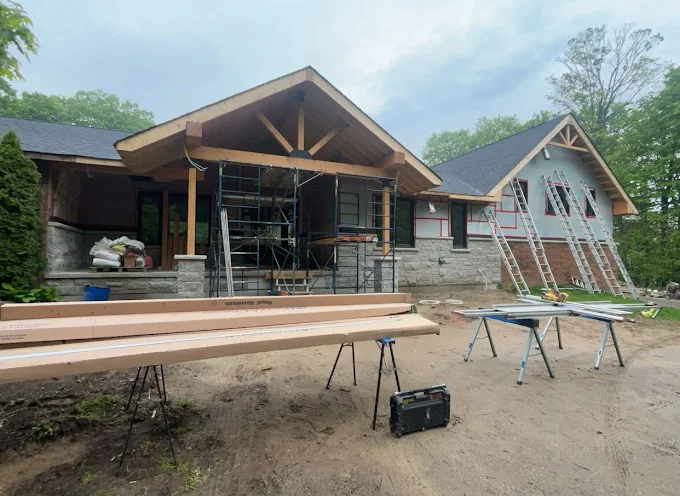 Large home addition framed and open during exterior construction.