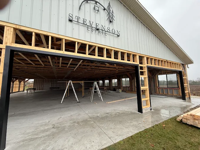 Large structure wrapped and prepared during exterior enclosure work.